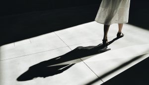 Woman in skirt walking casting shadow