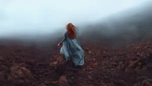Goddess Brigit running through misty landscape