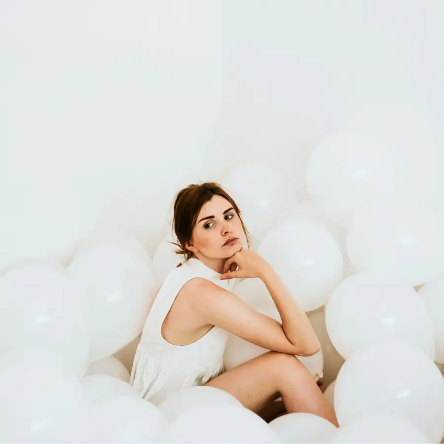 women with a white moon menstrual cycle on white background with white balloons