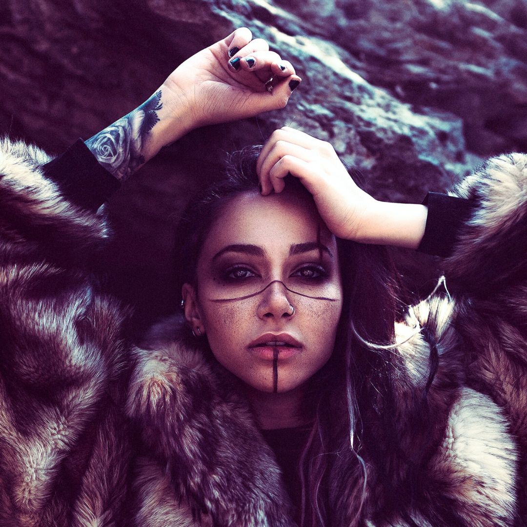 dark side of new femininity movement woman with face paint and furs