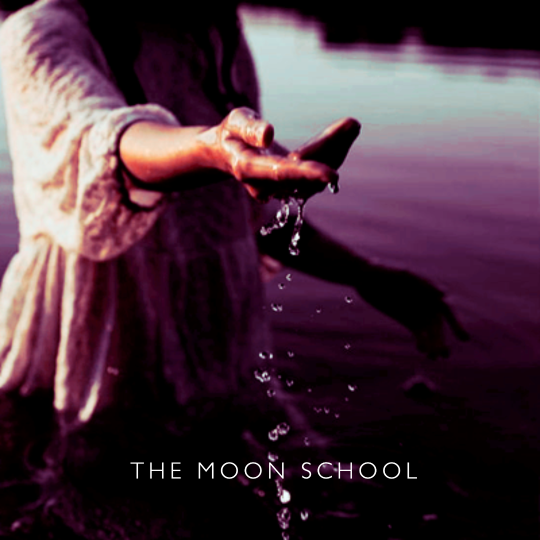 Witchy woman in a lake dripping Moon water from hand