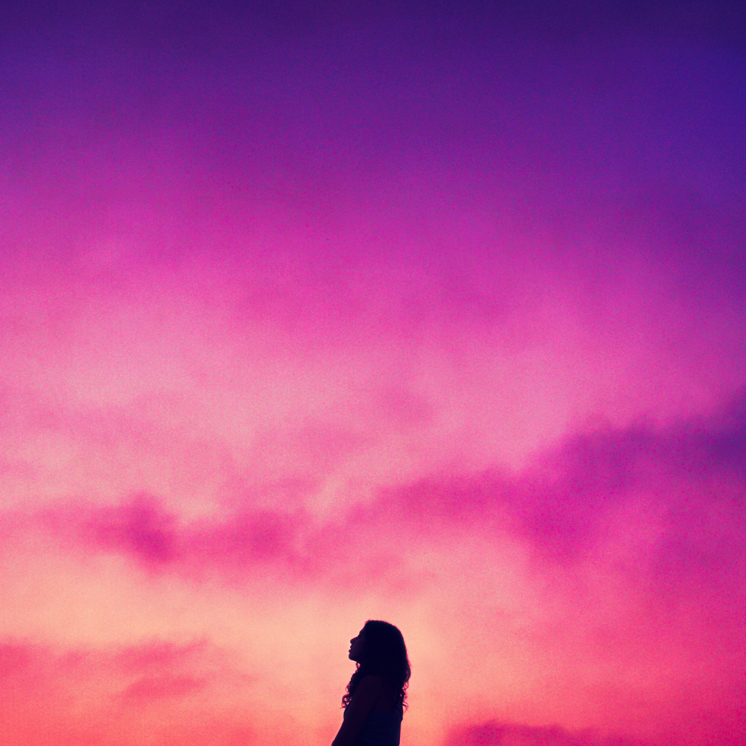 Woman Moon Gazing under a vast pink sky