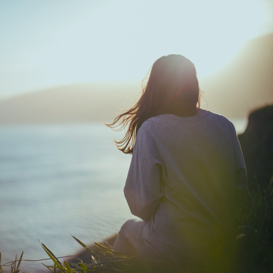 Woman moon gazing beside the ocean