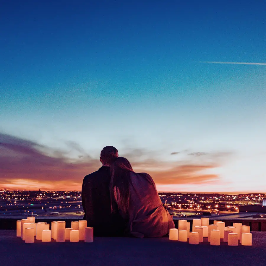 Couple watching sunset with candles