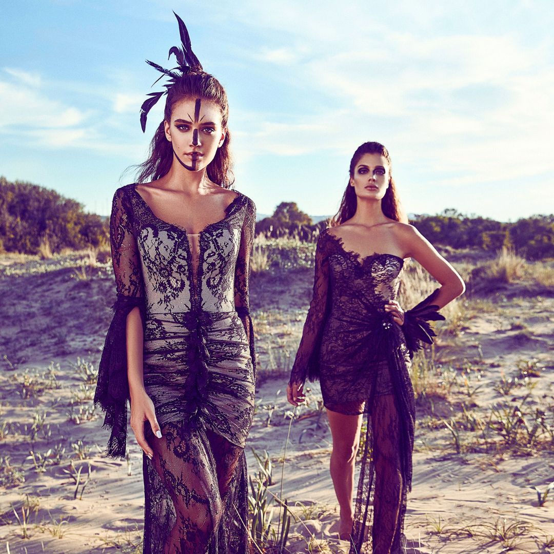 Two women with face paint and feathers expressing their goddess