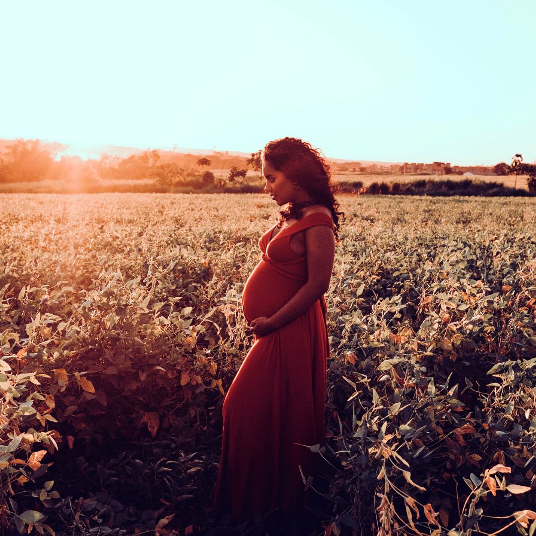 pregnant mother archetype in sunset field