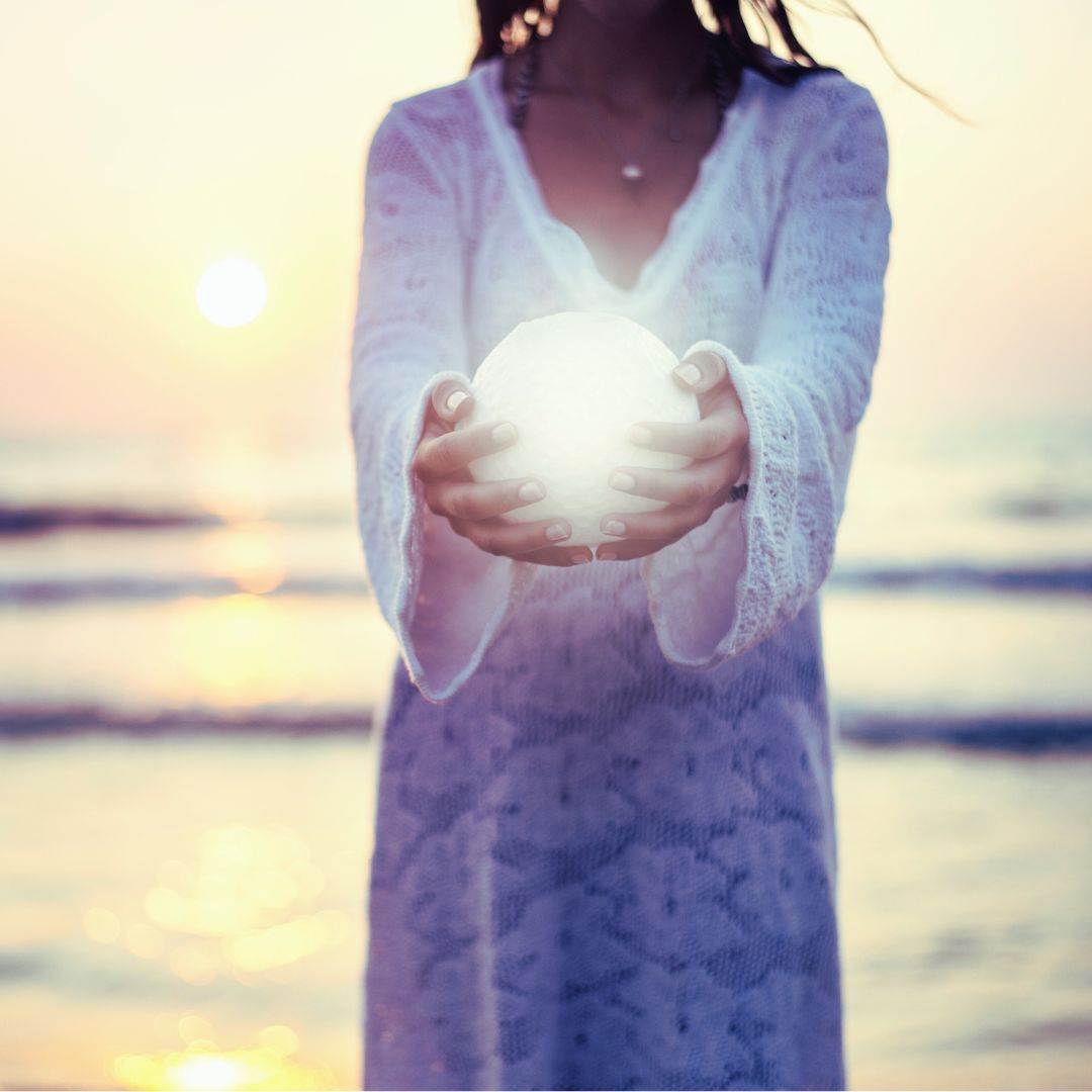 Woman holding a full Moon