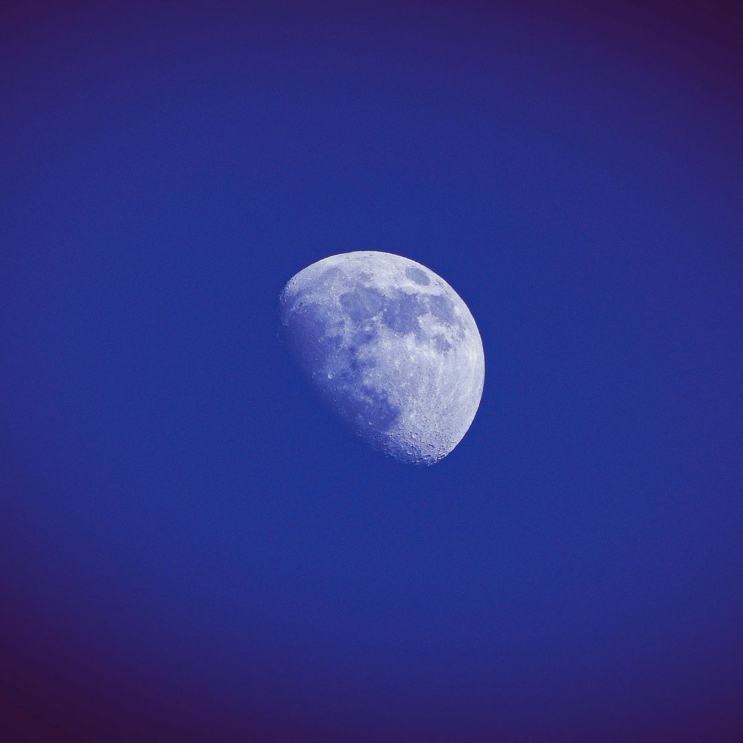 Waxing gibbous Moon in dark blue sky