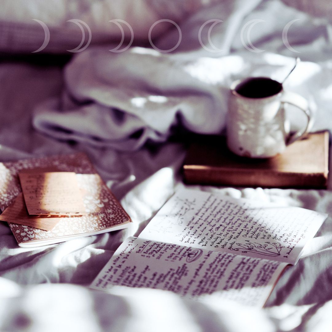 Journal open on a bed with sunight 
