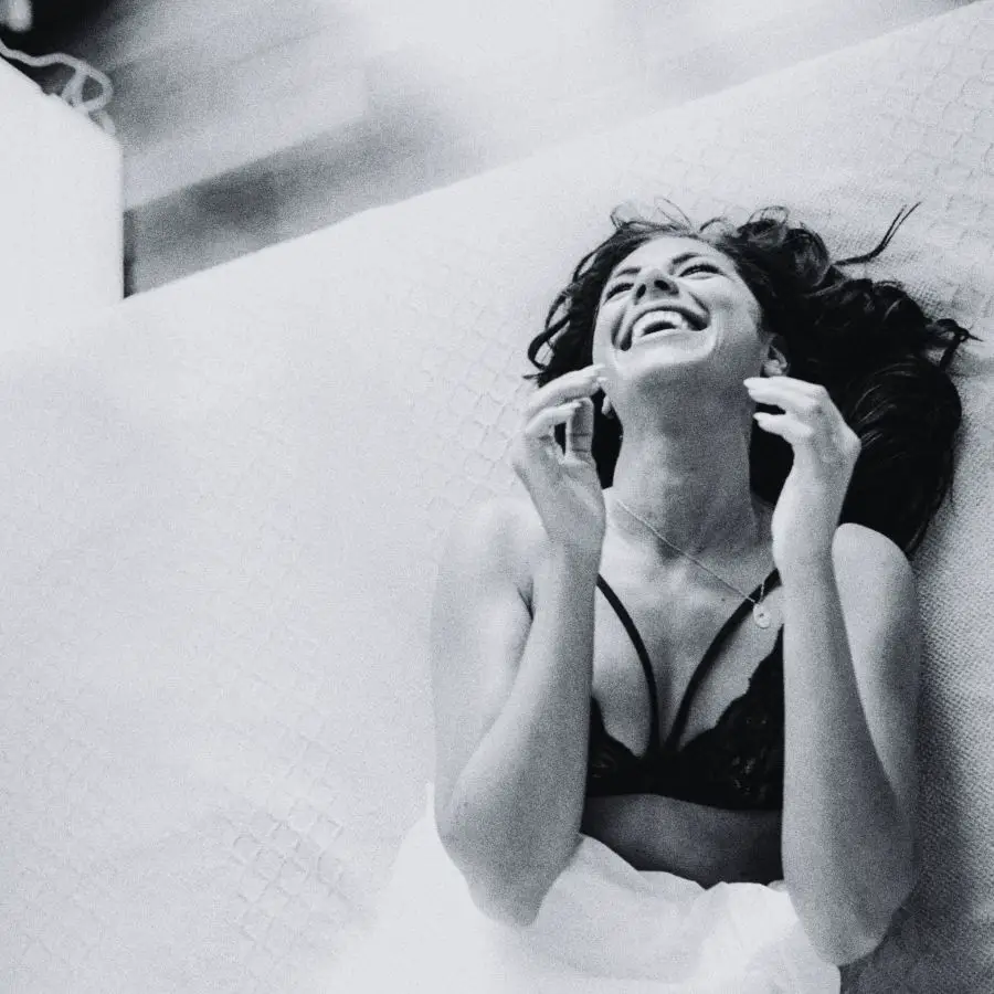 Moon in Leo woman laughing in bed