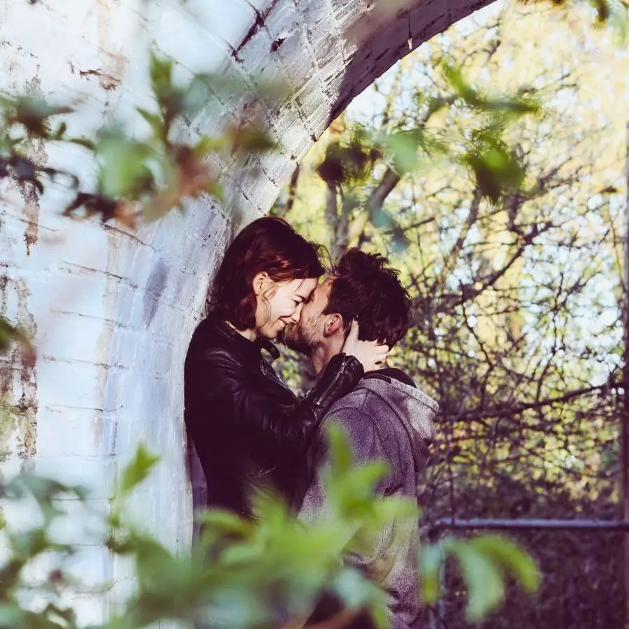 Sagittarius Moon woman and man embracing out of doors under a bridge