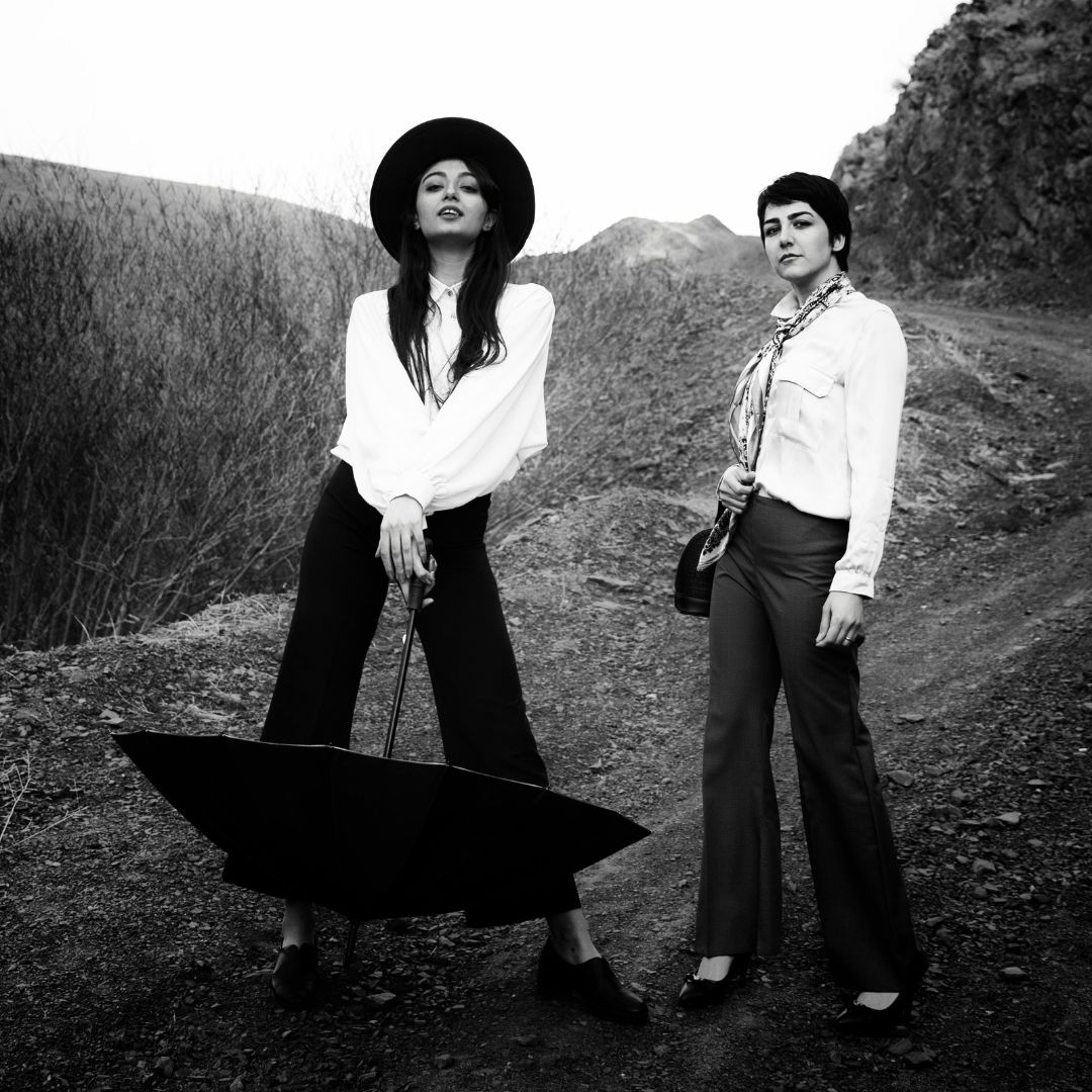 Black and white photo of authentic feminine women on a mountain path