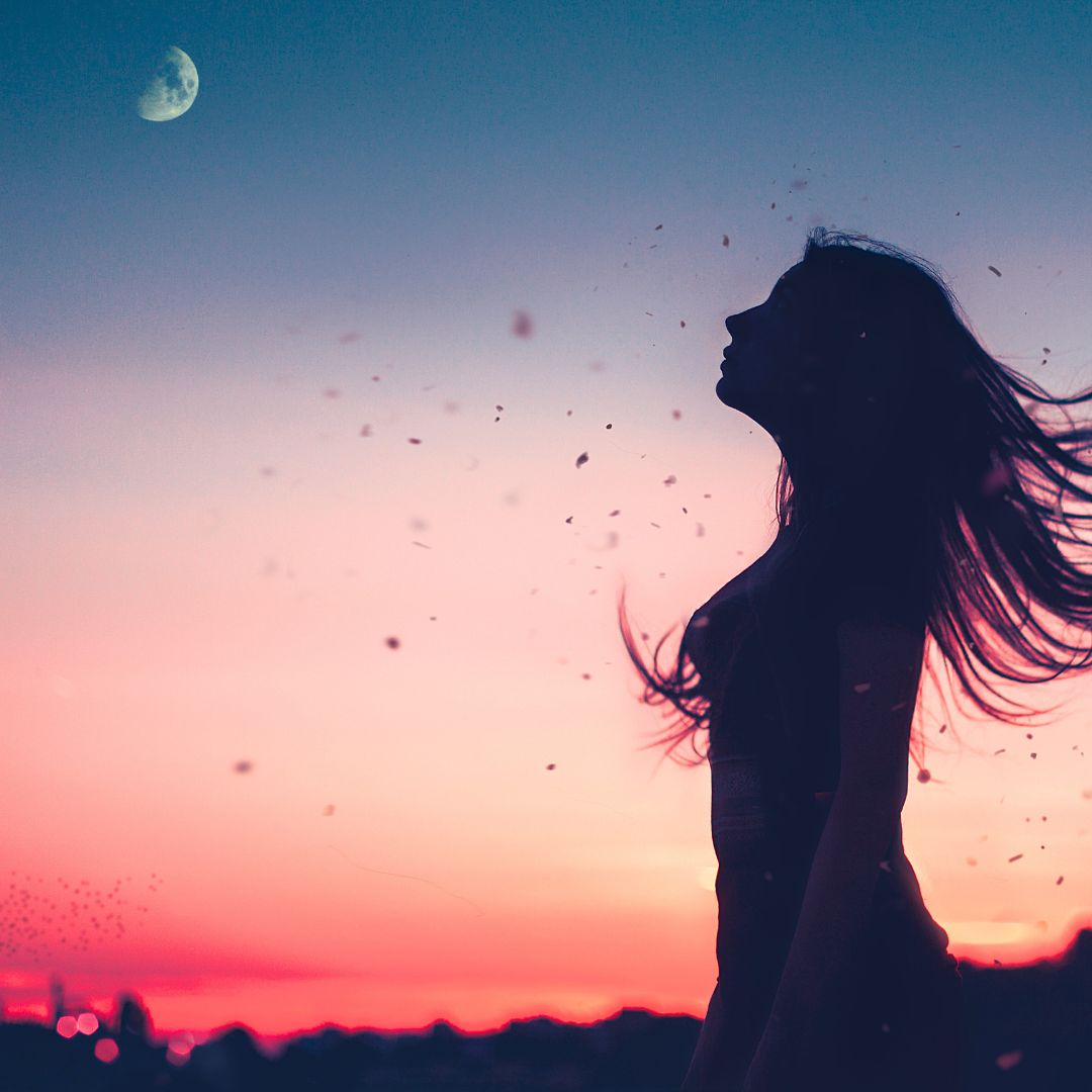 Woman aligning life with the first quarter Moon phase