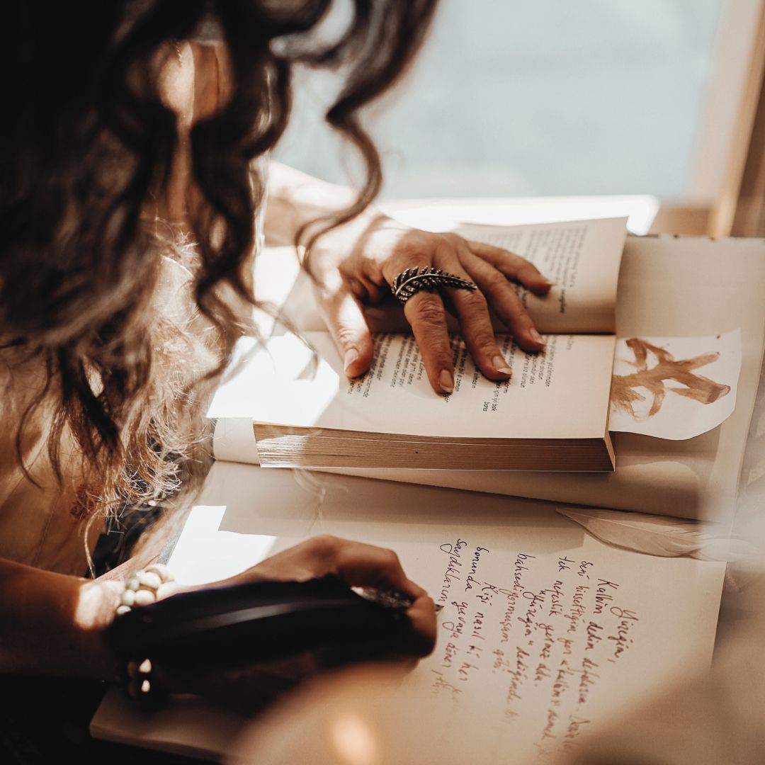 Woman writing intentions in journal