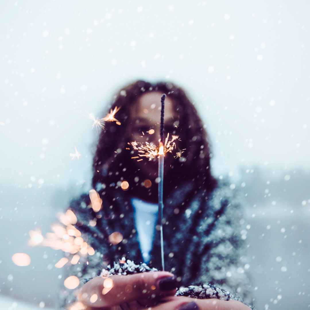 Woman with sparkler celebrating winter solstice