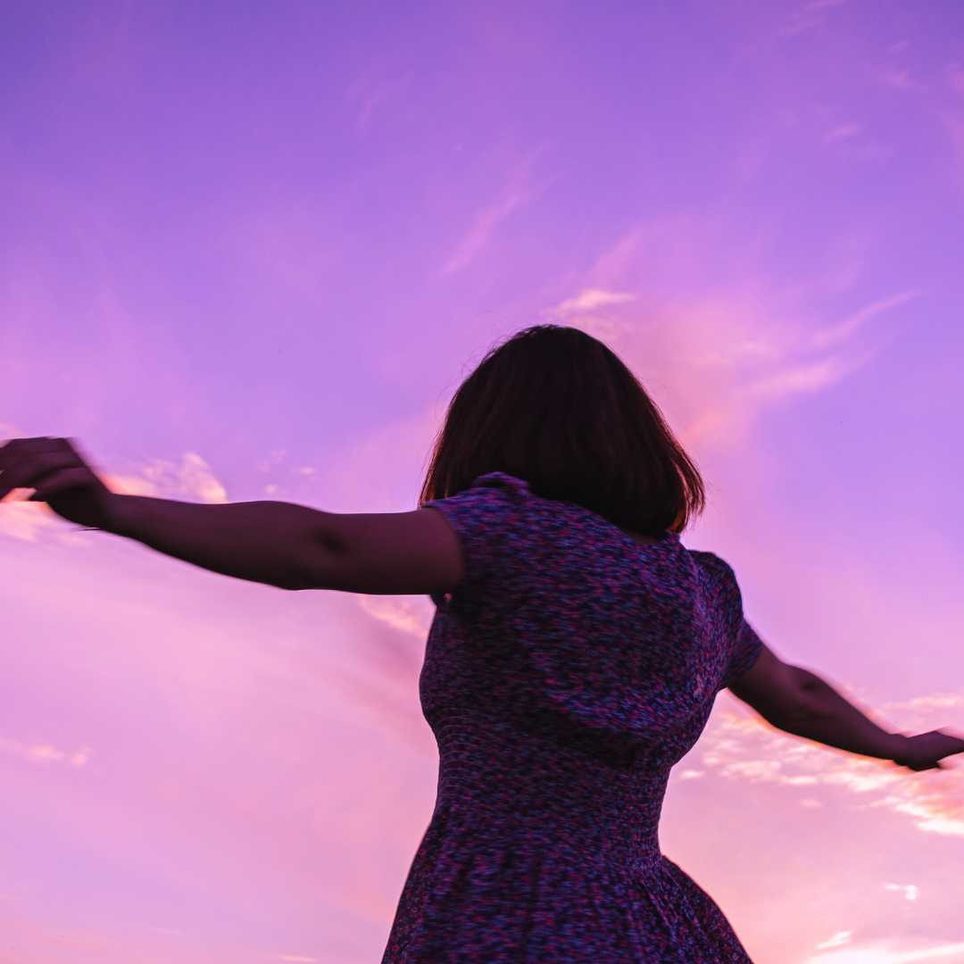 Woman with purple Moon cycle under a purple sky