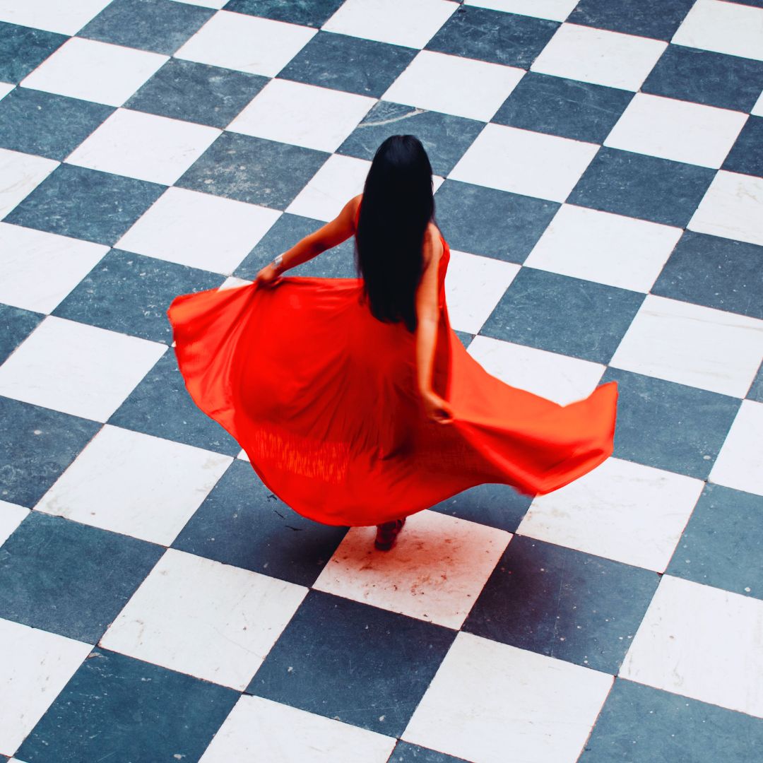 woman on her period dancing in a red dress