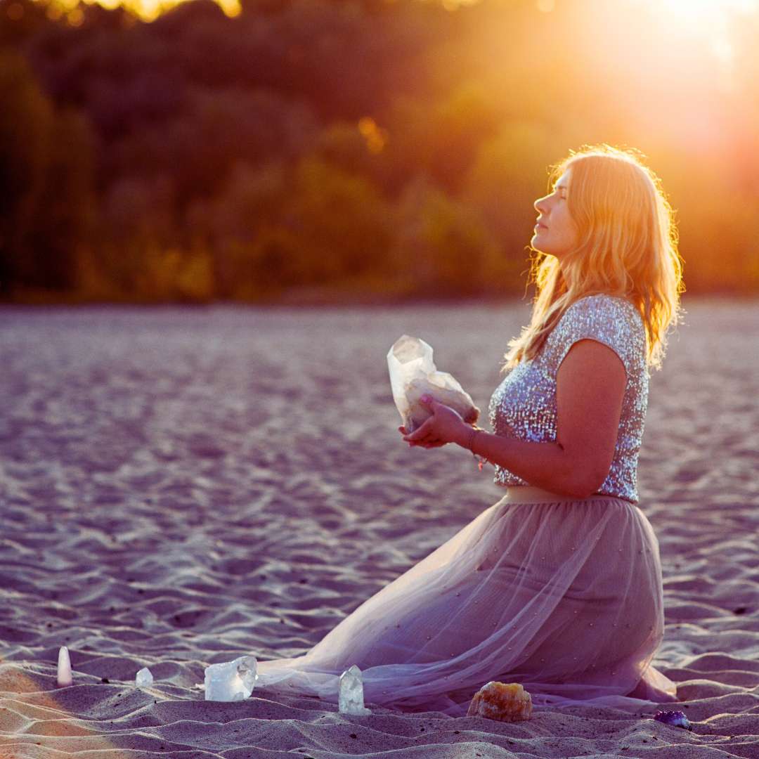 Woman on beach in fresh air charging crystals