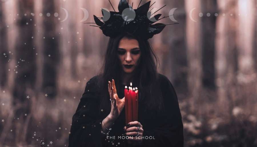 Witchy woman performing a candle ritual during a scorpio Moon
