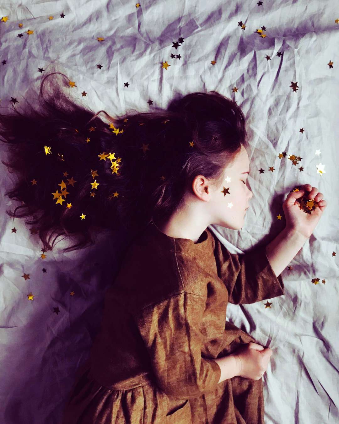 Girl with stars in her hair sleeping at the full Moon