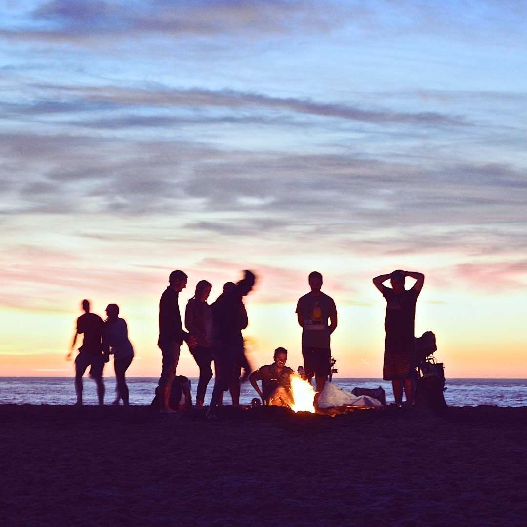 Group of people around a bonfire celebrating the flower full Moon