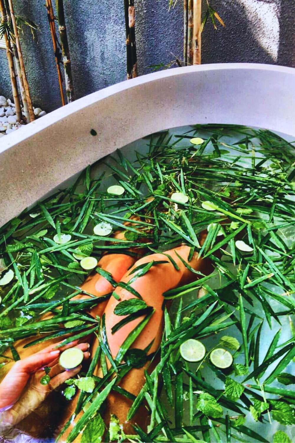 Spiritual woman taking a spiritual bath with cucumber and aloe