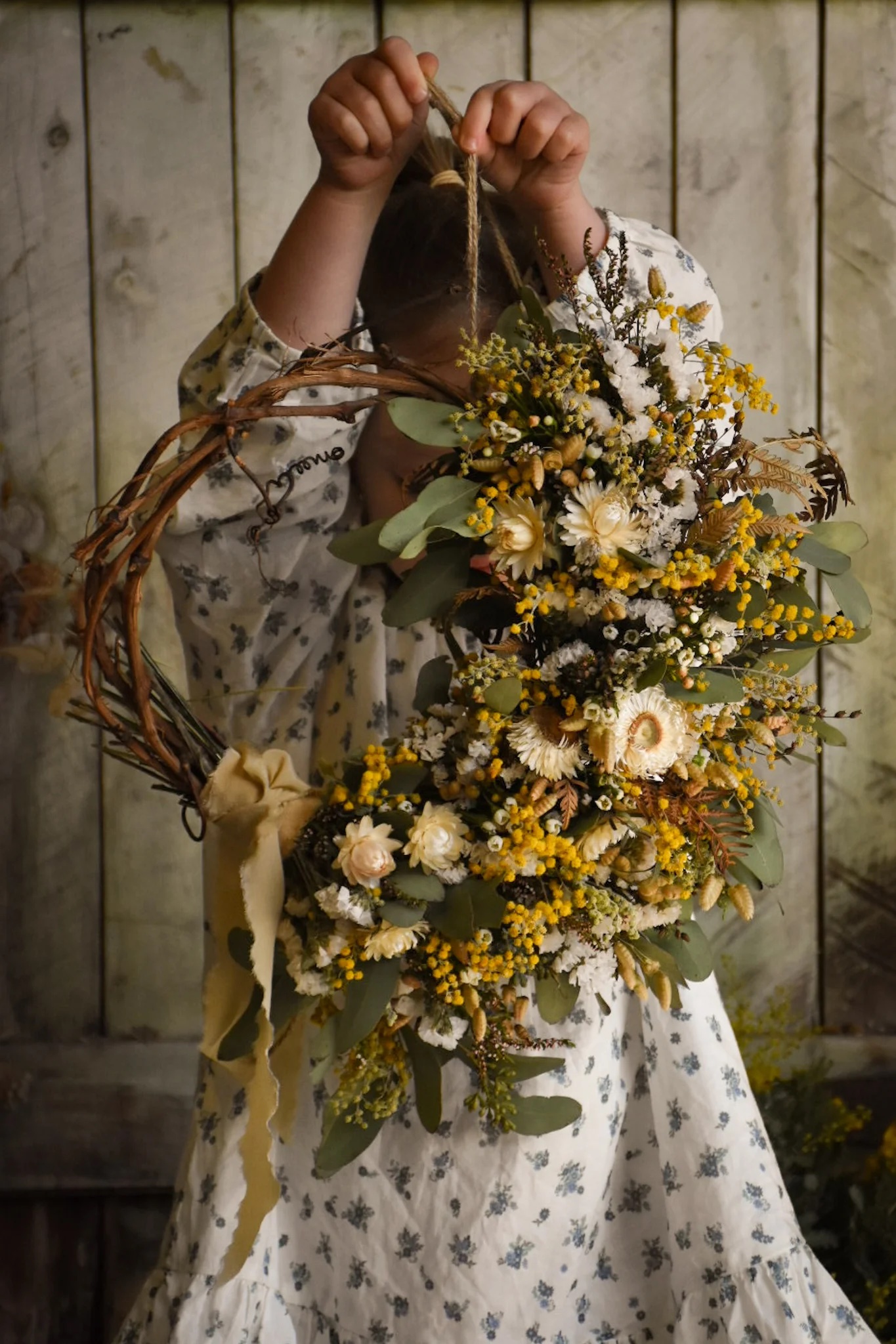 child celebrating Litha with a summer solstice wreath