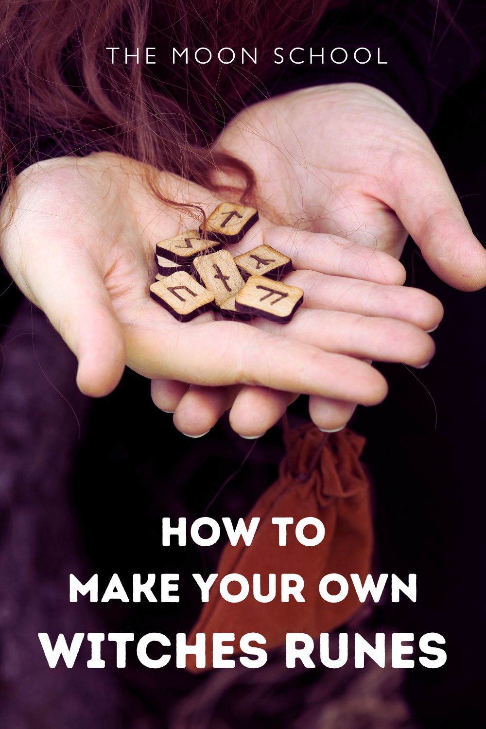 Woman's hands holding a set of witches runes