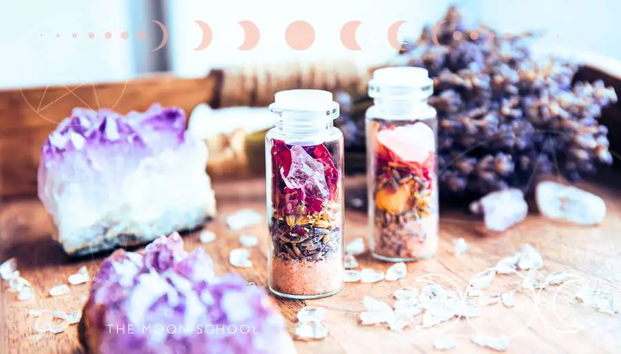 Image of spell jars with herbs and crystals, surrounded by amethyst and lavender for winter solstice dreaming