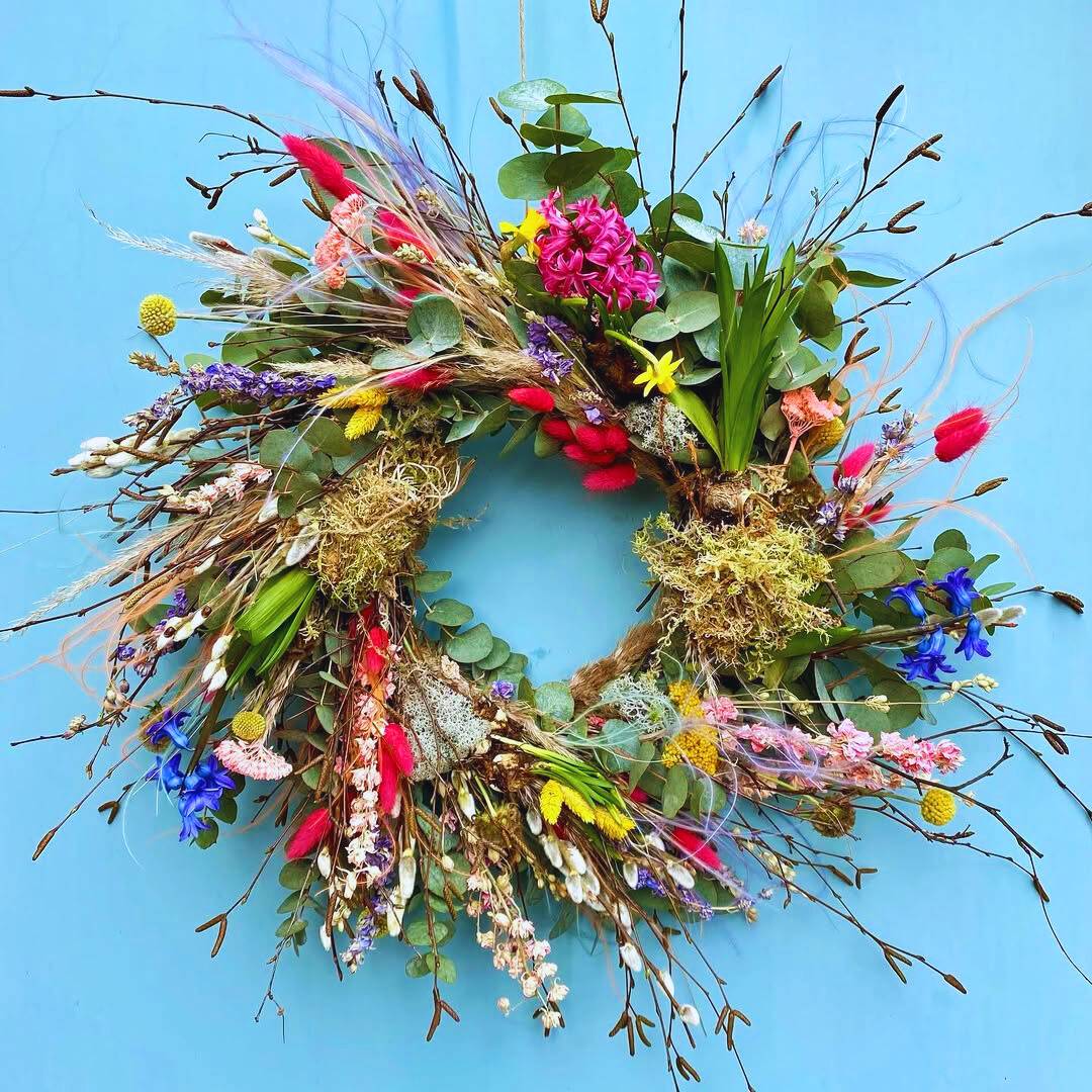 Bright spring wreath design on a blue background