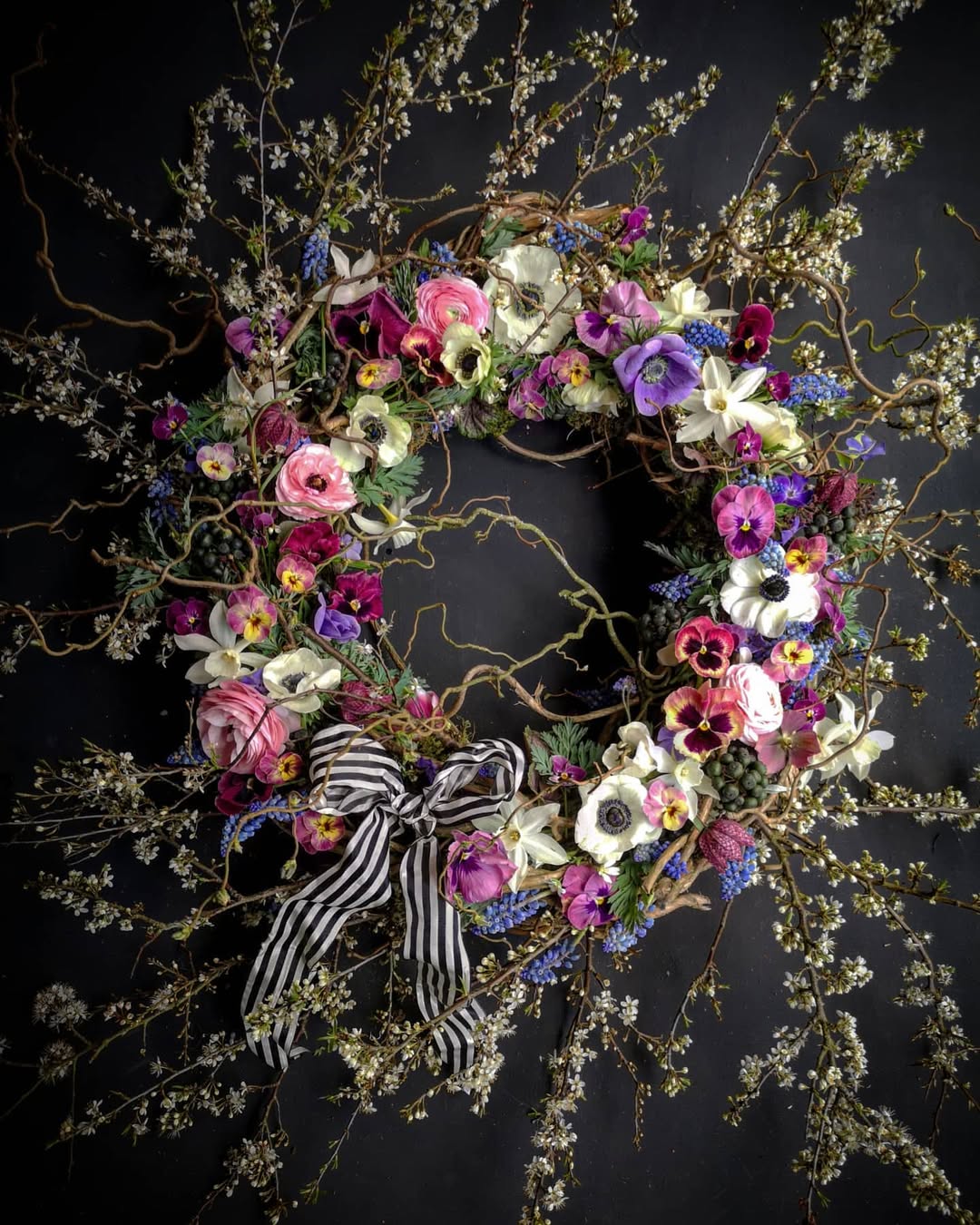 Large pink, purple, white spring flower wreath with anemones and pinstripe ribbon