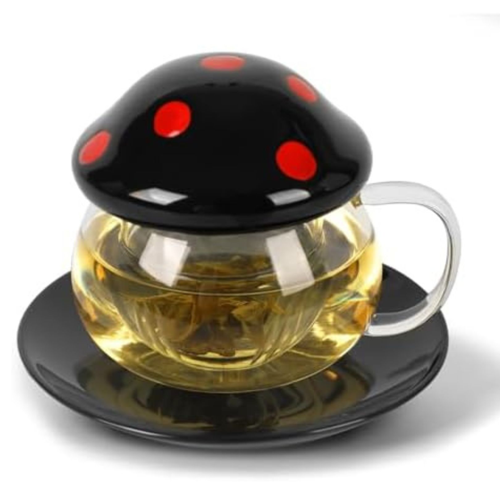 Ceramic black and red mushroom style tea infuser on a glass tea cup