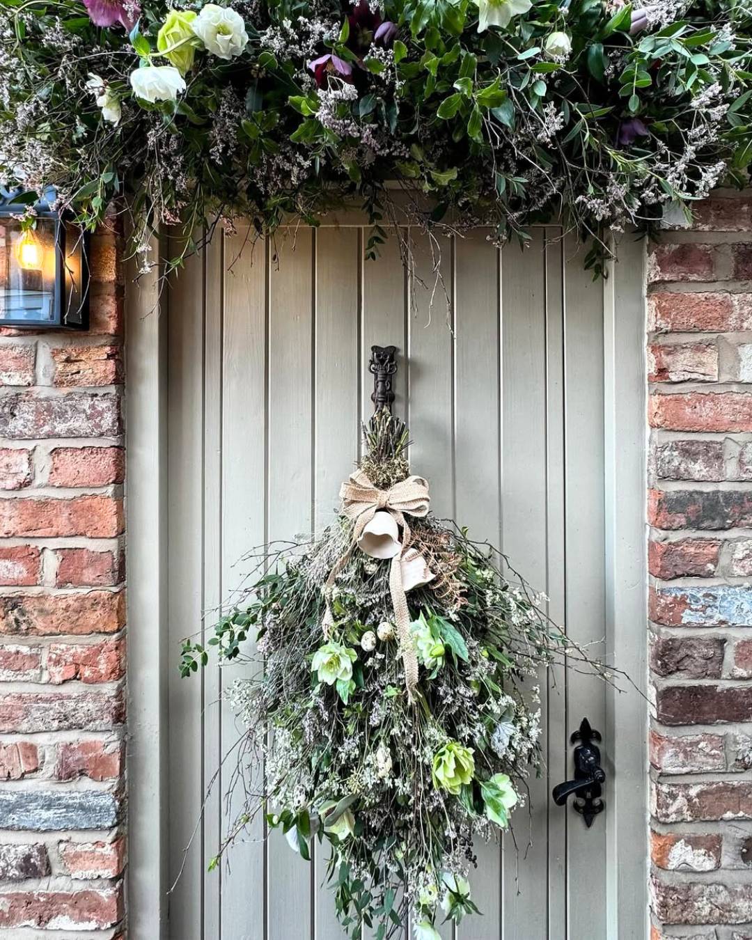 light green front door with hanging witchy DIY spring broom decoration idea