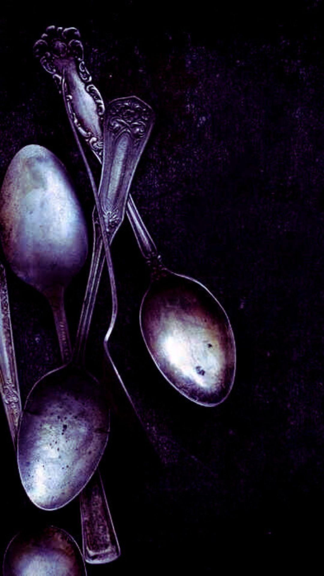 Muted dark photo of vintage witchy teaspoons