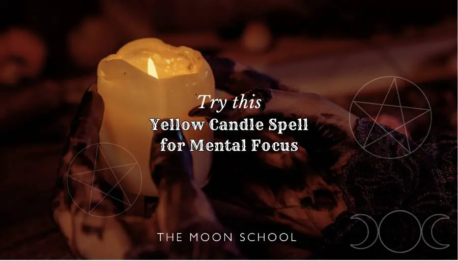 witchy hands holding a yellow pillar candle on a mystical dark spiritual altar