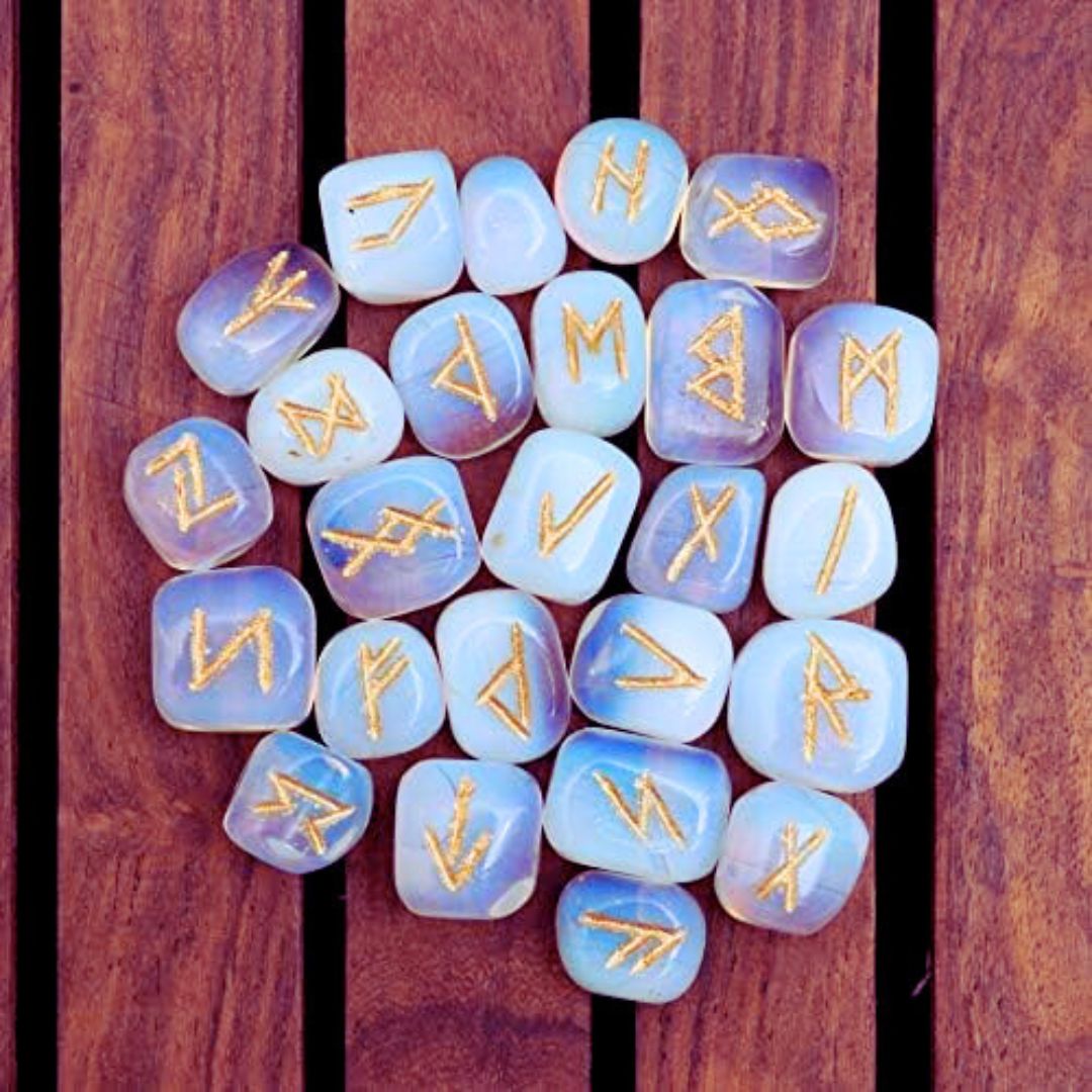 Selection of white opalite runes engraved in gold