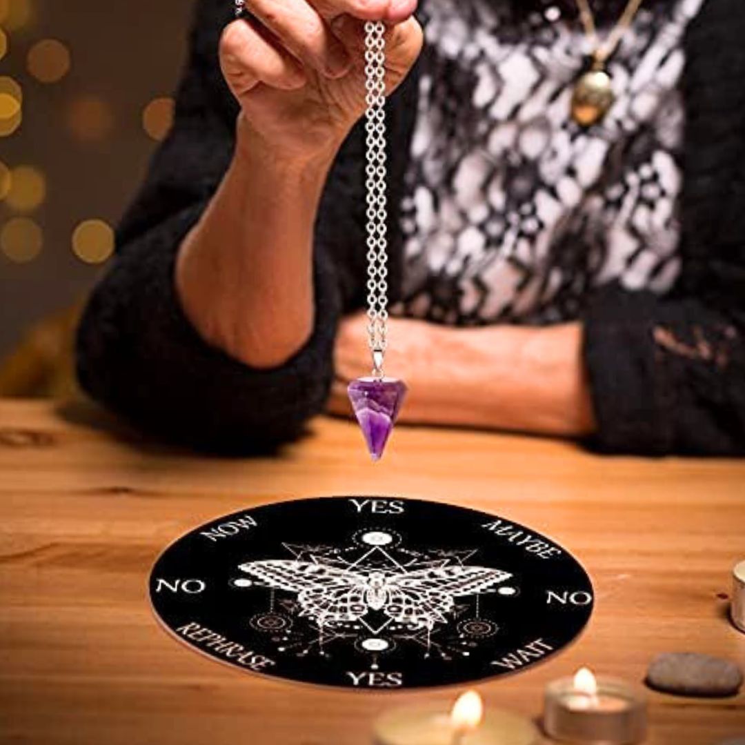 witch's pendulum divination set up with black butterfly design dowsing cloth