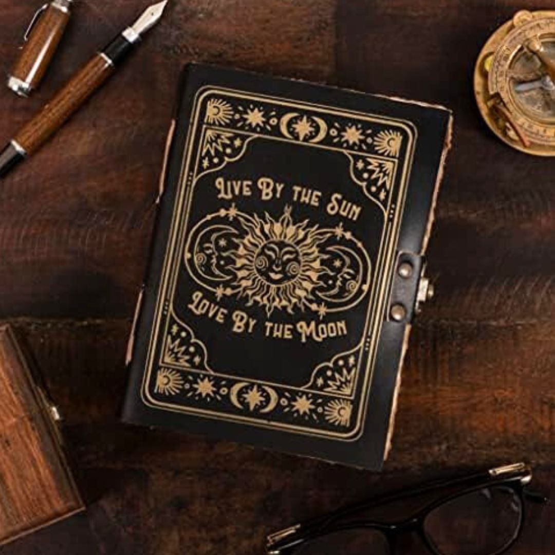 sun and moon design black leather bound book of shadows