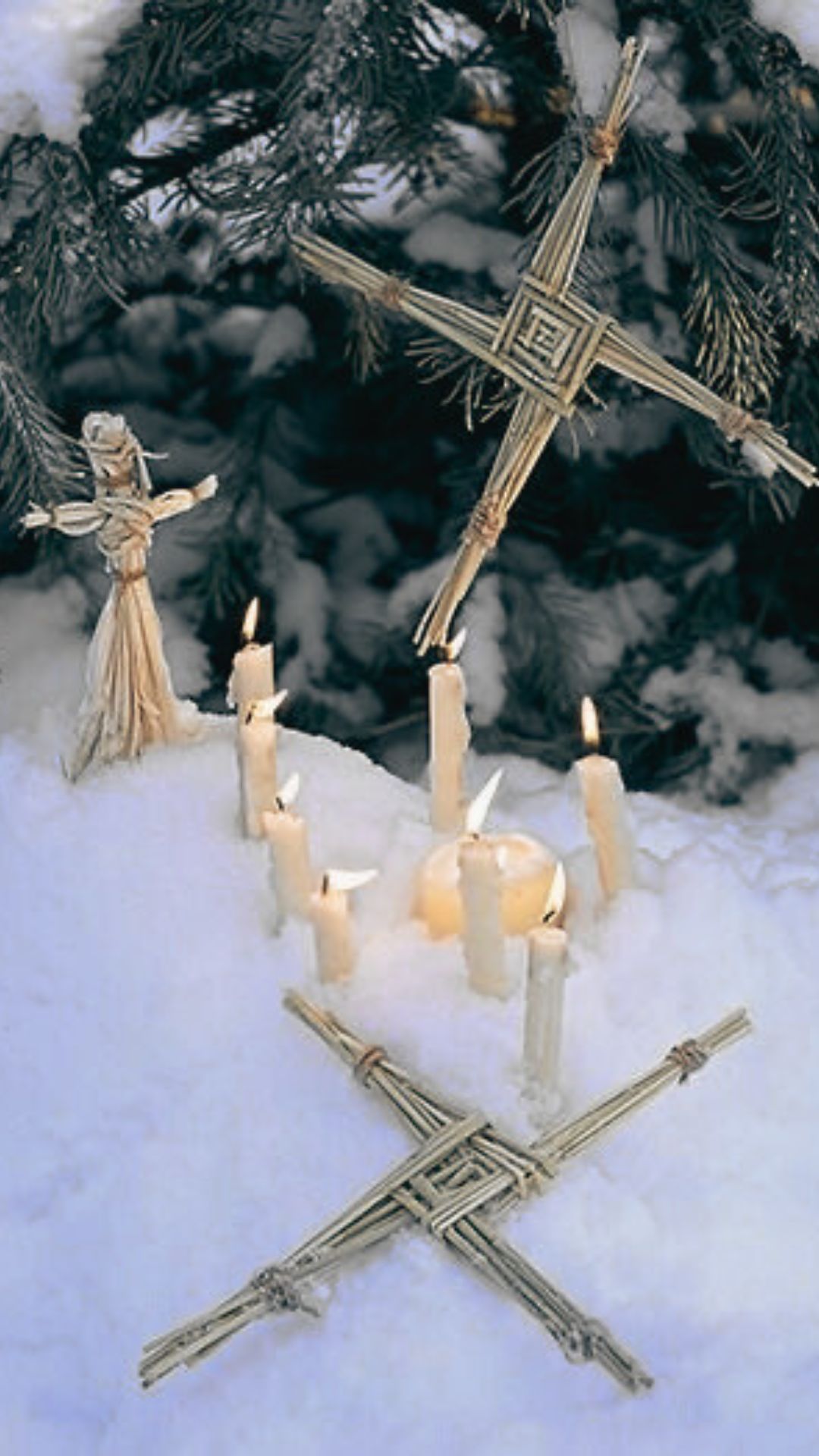 Imbolc altar in the snow with st brigid's cross Imbolc altar in the snow with st brigid's cross